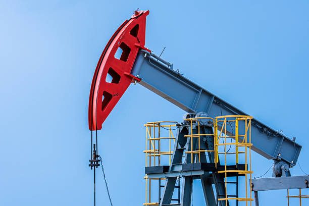Oil drilling derrick pumps oil from ground. Petroleum industry, crude oil extraction. Production of fuel from natural resources. Oil crisis.
