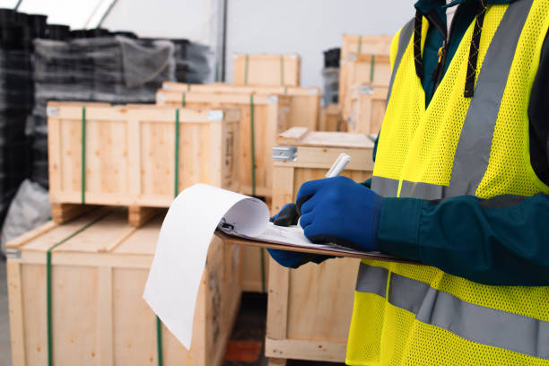 Warehouse Worker in Safety Gear Checking Inventory